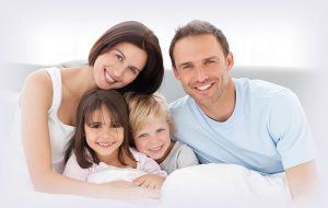 family of four smiling